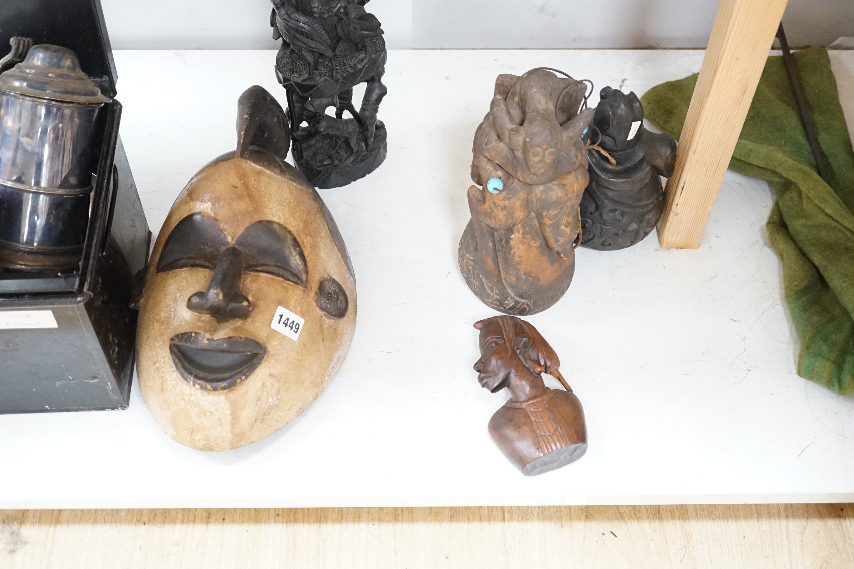 Two African tribal masks, a carved gourd vessel, four wood carvings and an instrument, tallest 36cm high (8)